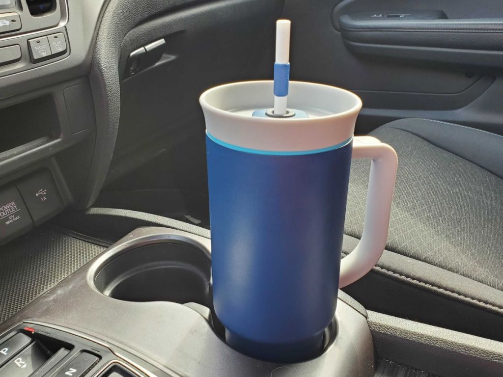 A stainless steel tumbler in a car