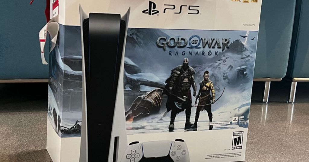 PS5 God of War Ragnarok Edition Console on floor in front of a couch