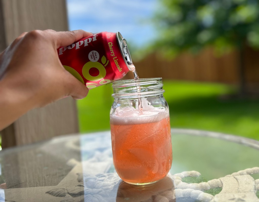 Pouring Poppi Prebiotic Soda into a mason jar