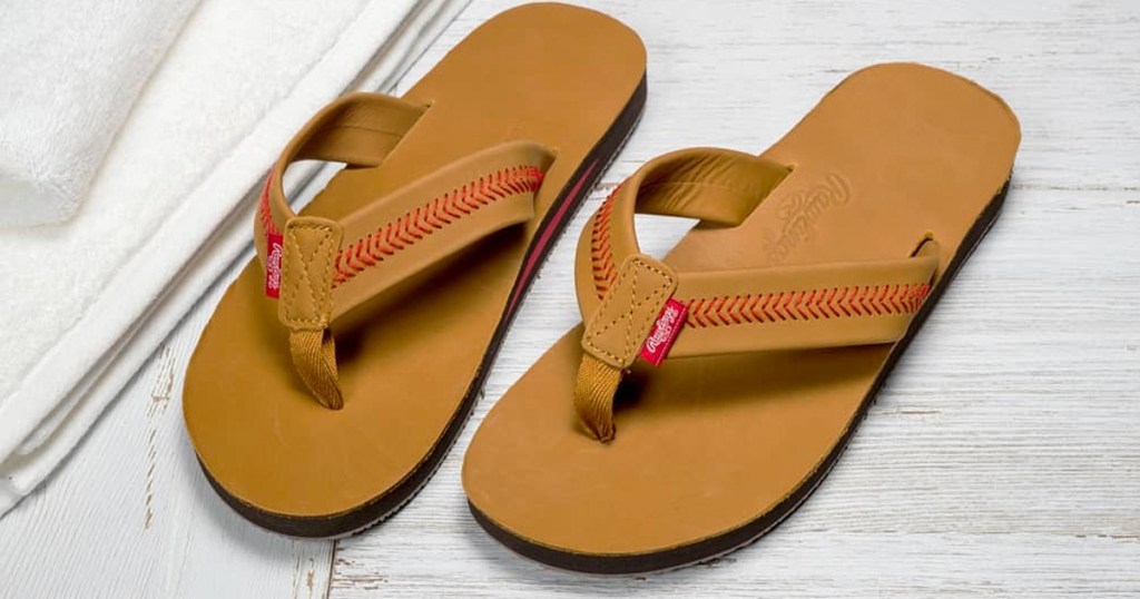 pair of brown leather sandals with red baseball stitching