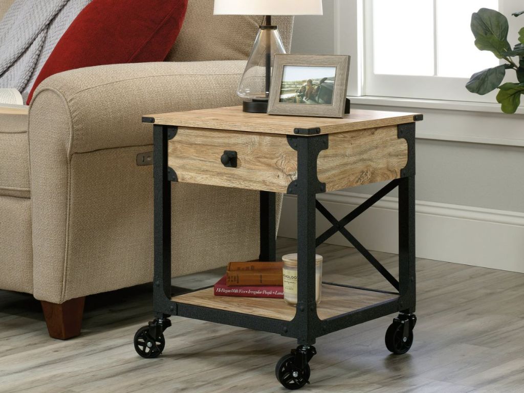Sauder steel and wood rolling side table next to a couch