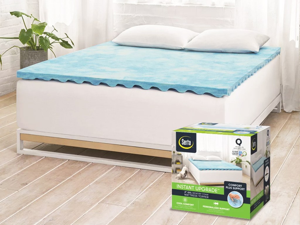 blue mattress topped on a mattress with box on floor in front of bed