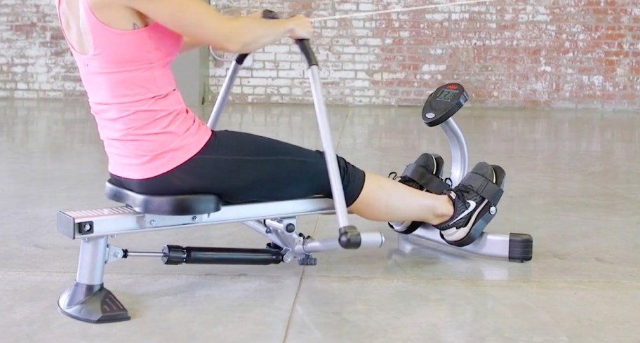 woman sitting on rowing machine