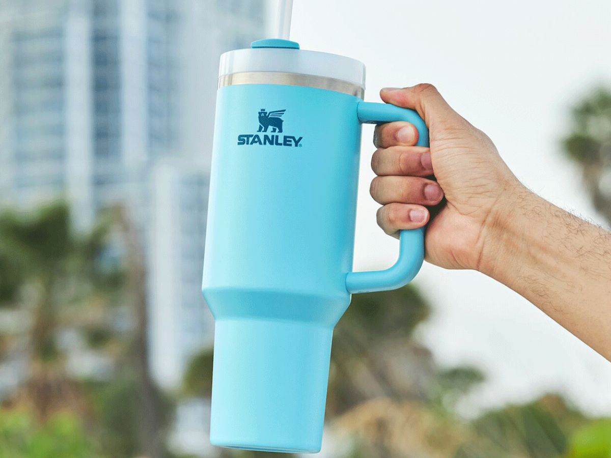 Stanley 40oz Tumbler in new pool blue shade being held up in a hand