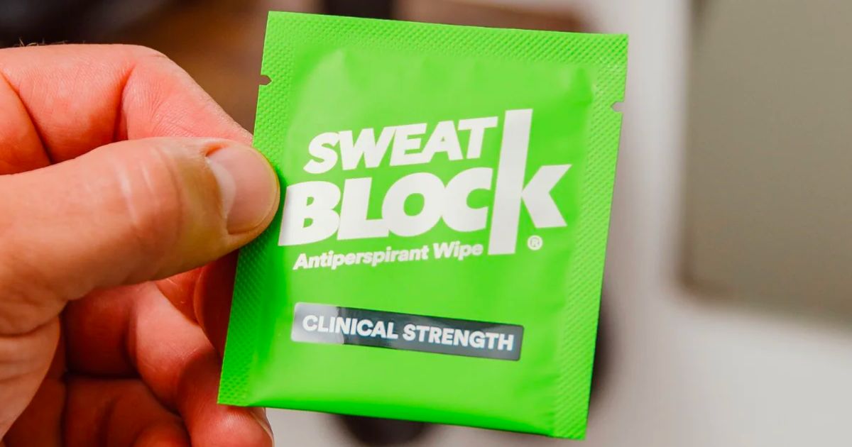 a mans hand holding a Sweat block packet