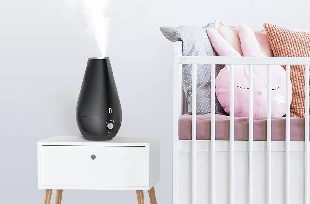 Humidifier sitting on a nightstand by a crib