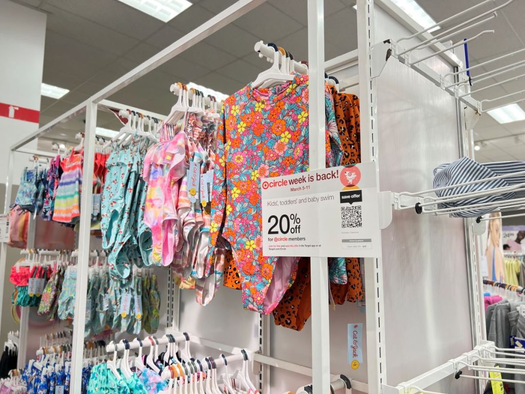 Display of girls swimwear at Target and a sign mentioning 20% off