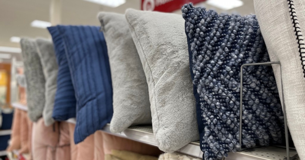 different colors and patterns of Throw Pillows on shelf in Target store