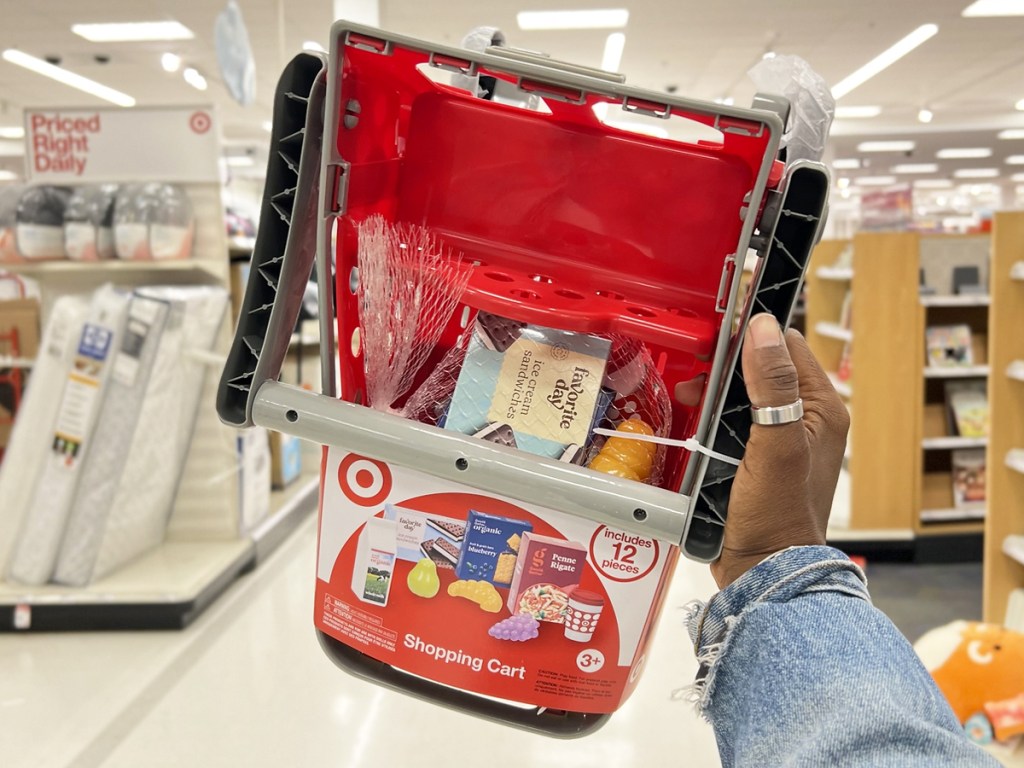 hand holding up Target Toy Shopping Cart