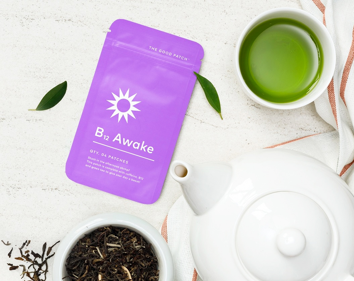 purple pack of The Good Patch B12 Awake patches near green tea and tea pot