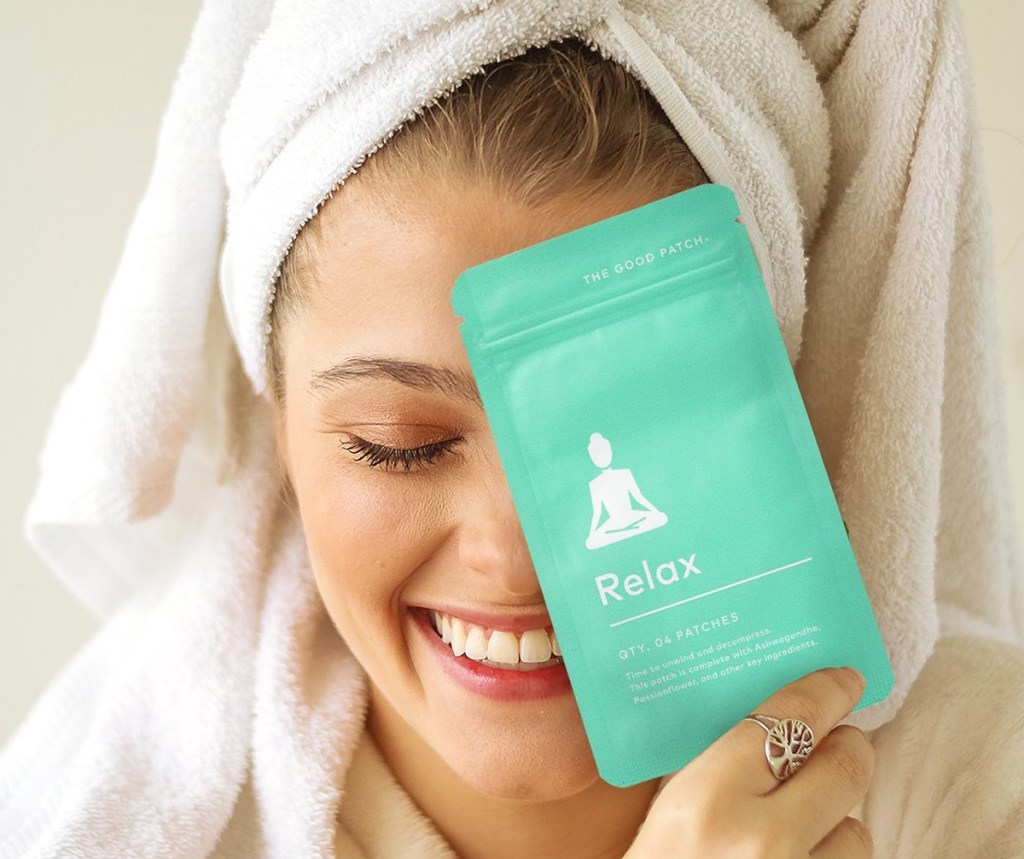 woman holding up pack of The Good Patch Relax patches