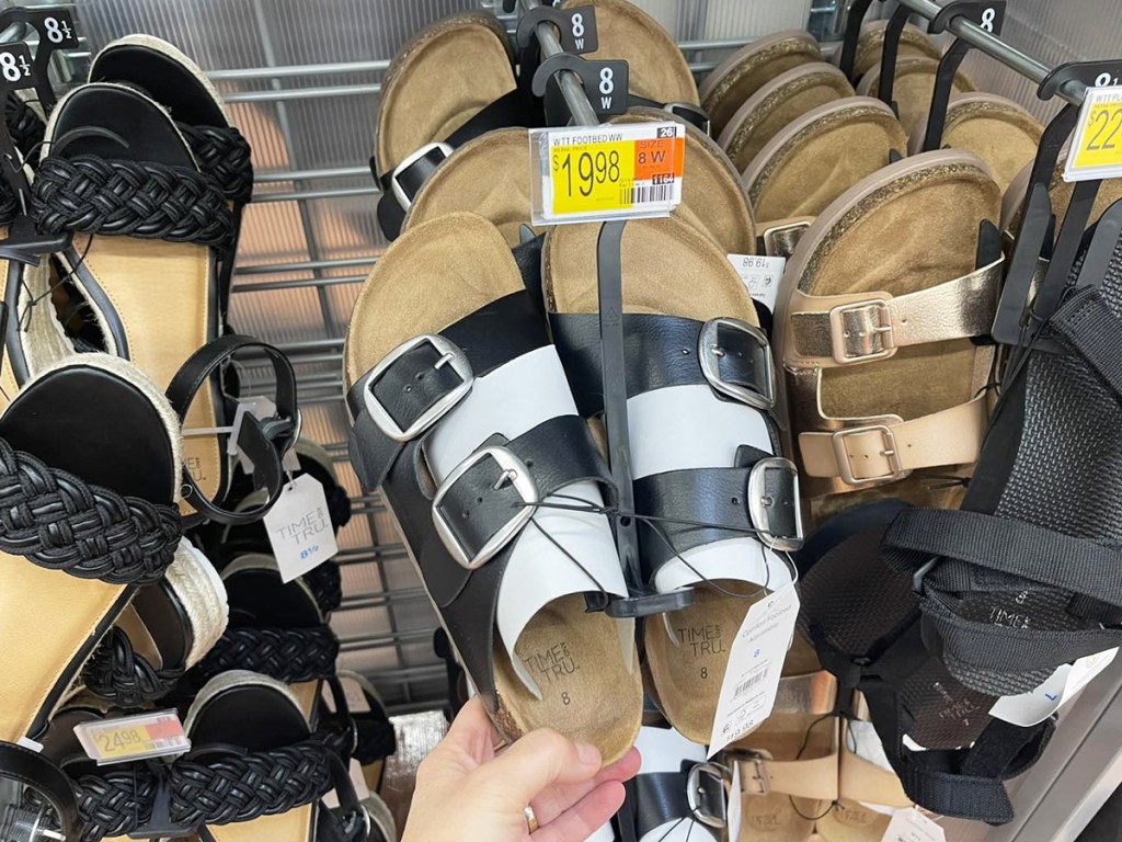 hand holding pair of footbed sandals