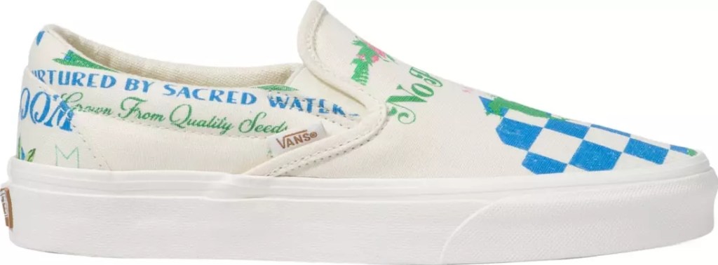 White Vans shoe with green and blue writing and a blue checkerboard pattern on the top