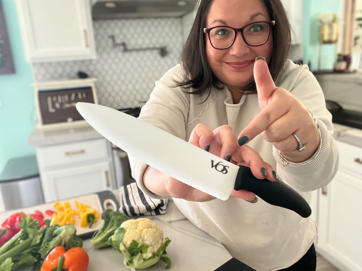 woman pointing to a large knife that she is holding