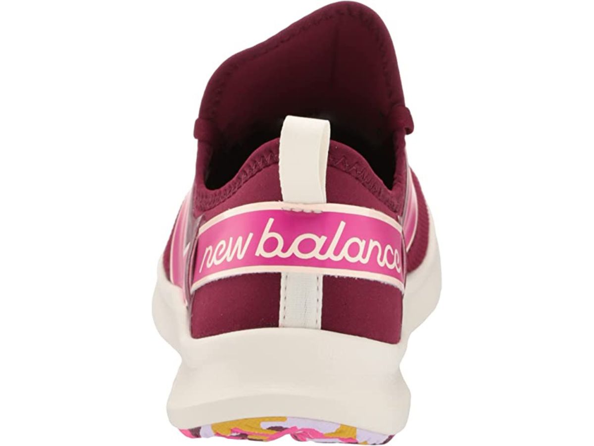 back of New Balance shoes with pink New Balance logo across the back