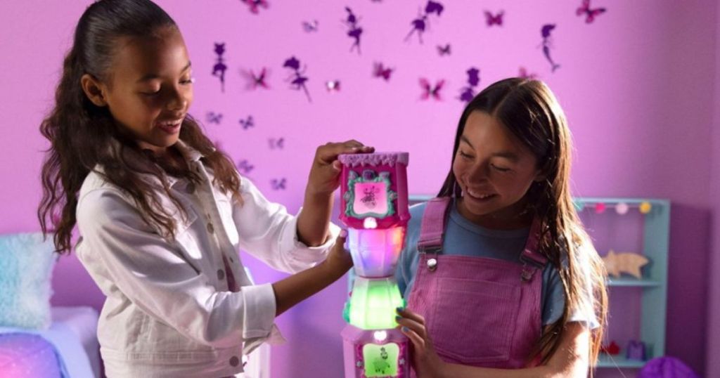 2 girls playing with glowing jars in bedroom