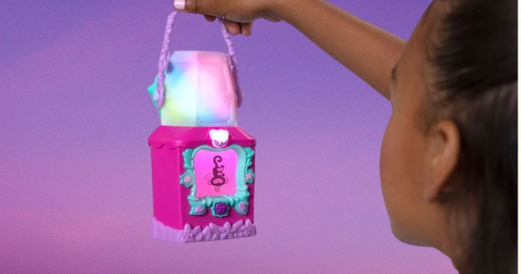 girl holdign onto hanging glow toy lantern