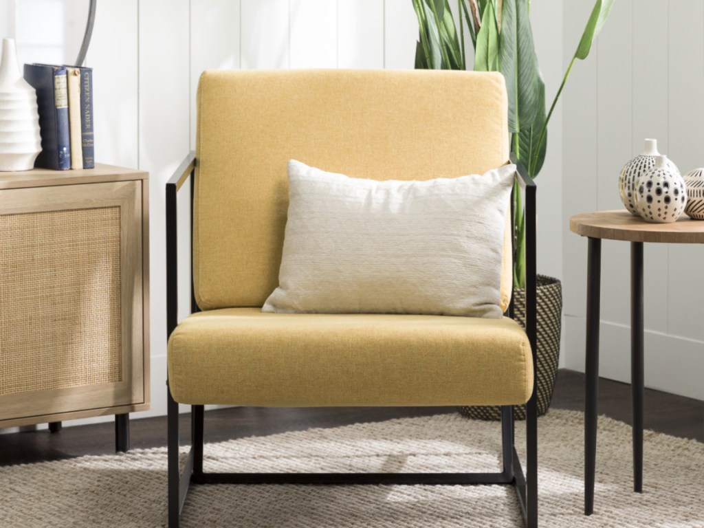 yellow cushioned chair with black frame in living room