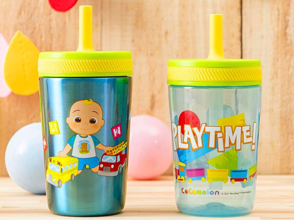 Zak Designs CoComelon Kelso 2-Pack Tumbler Set on a table with loose balloons in the background