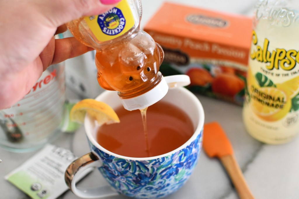 adding a drizzle of honey to tea