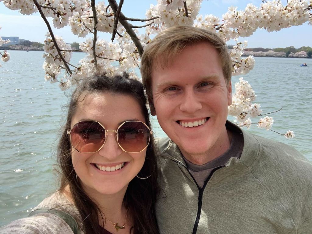 couple standing in front of dc cherry blossoms