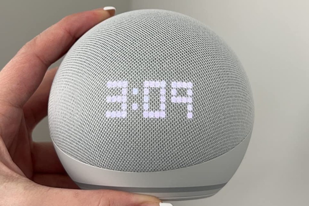 holding an Echo Dot showing the time