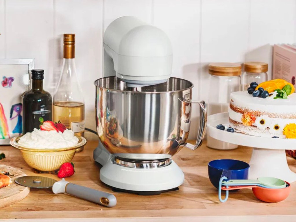 white stand mixer on table with baking supplies