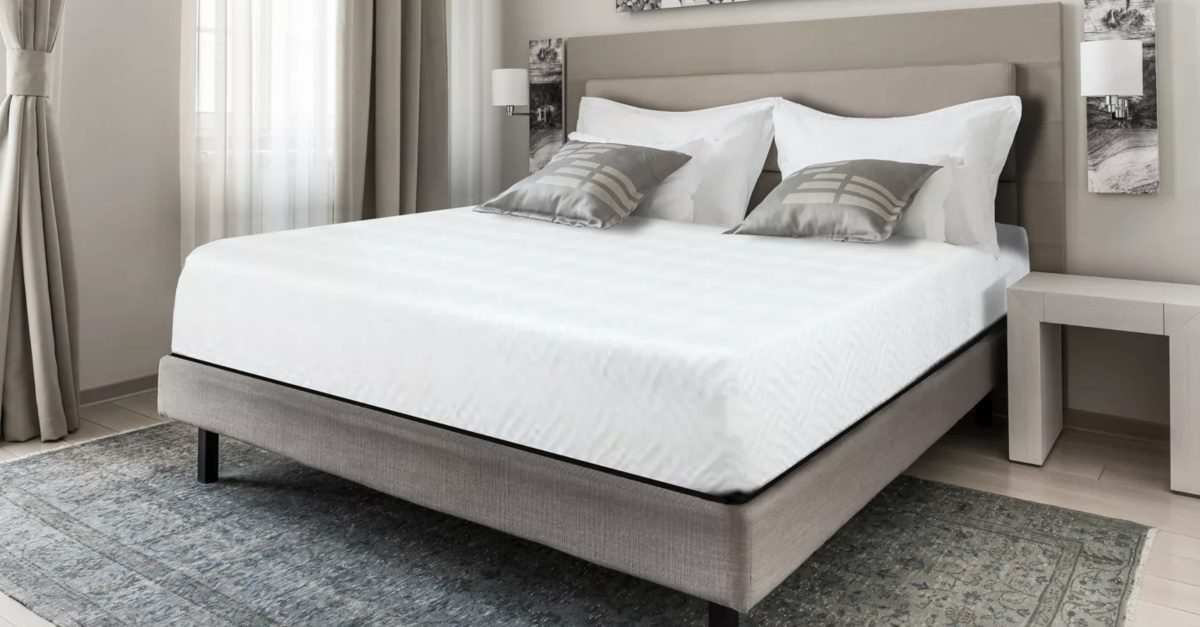 white mattress on fabric bedframe