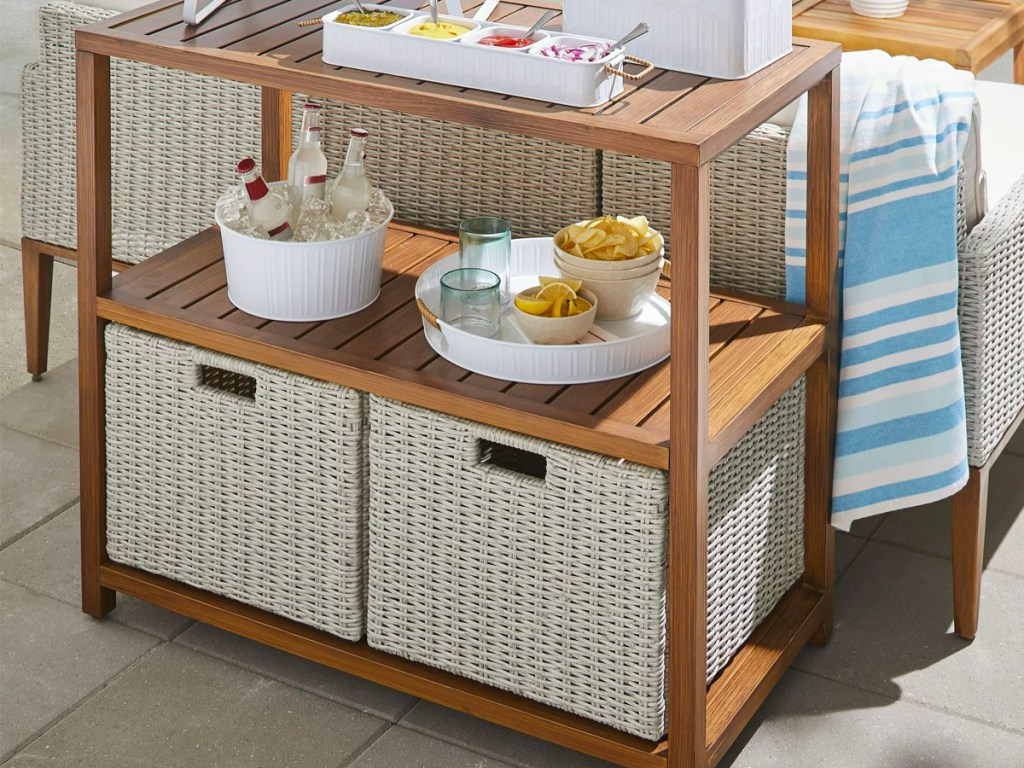wooden outdoor console table with white wicker baskets 