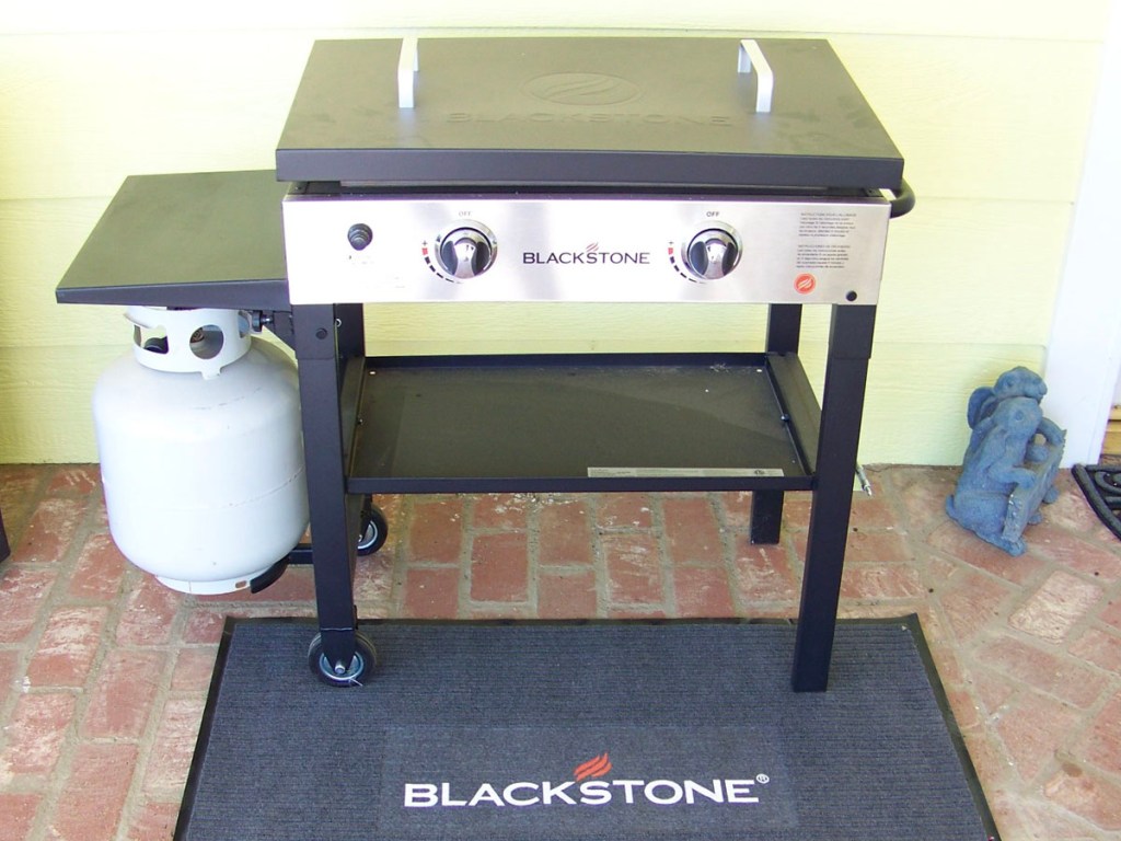 silver and black blackstone grill on porch