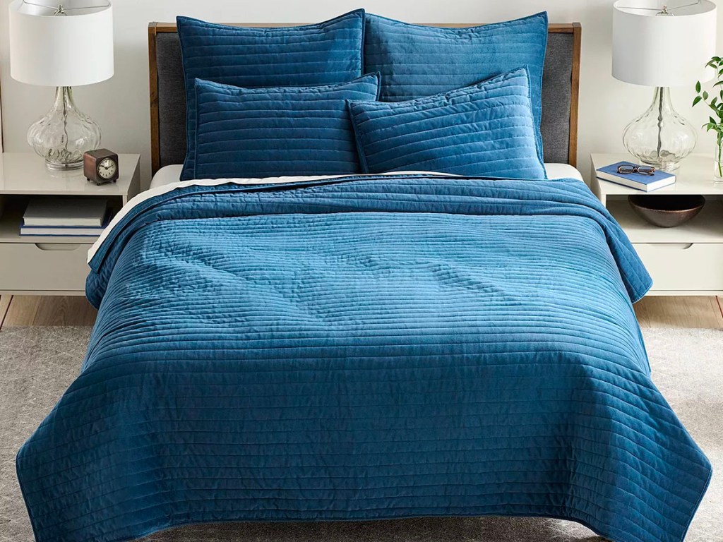 blue velvet comforter set on bed