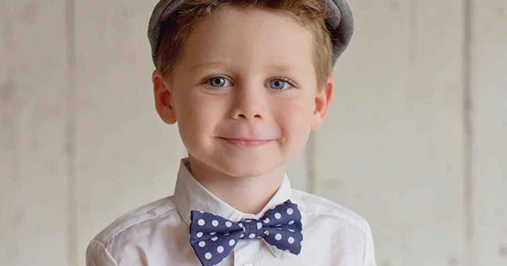 boy in polka dot bow tie and driver cap