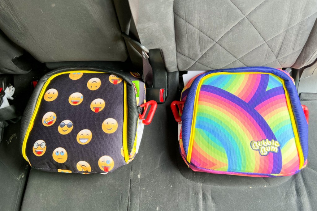 smiley face and rainbow inflatable booster seats in car