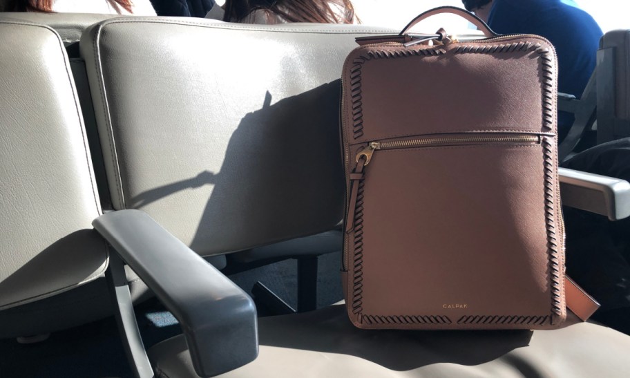 calpak Kaya Laptop Backpack on a chair in the airport