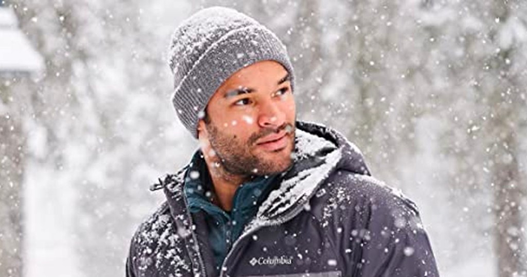 man wearing gray ale creek beanie in snow