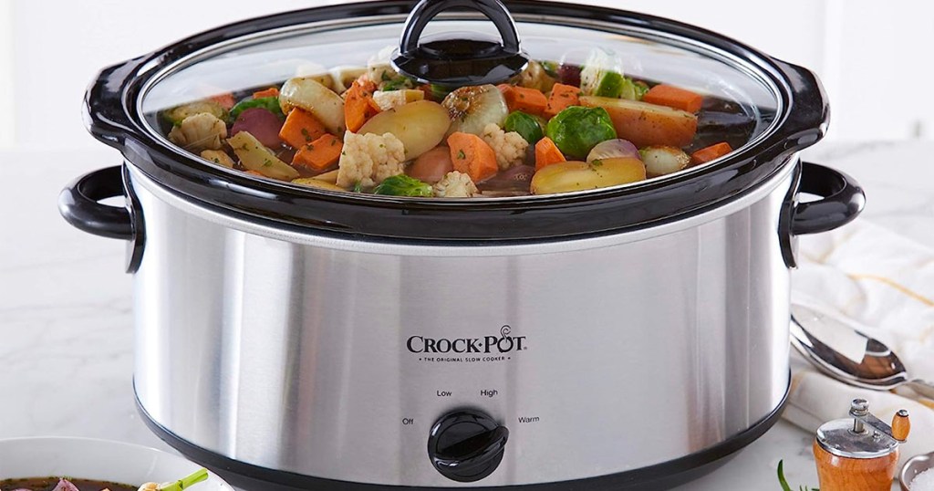 silver and black crockpot with vegetables cooking