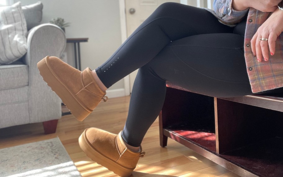 woman sitting on bench wearing platform ankle boots