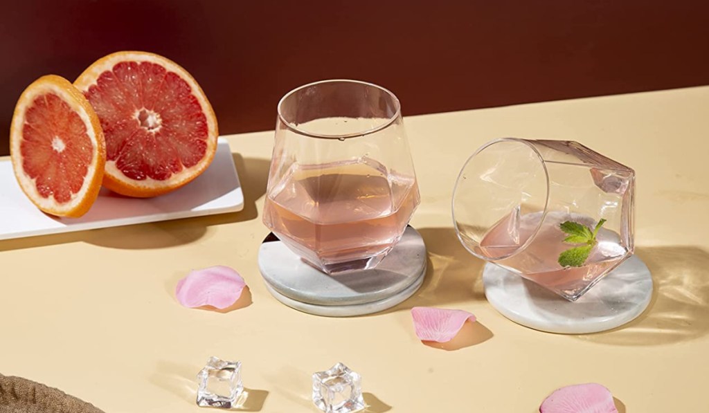 diamond shaped wine glasses filled with grape fruit juice