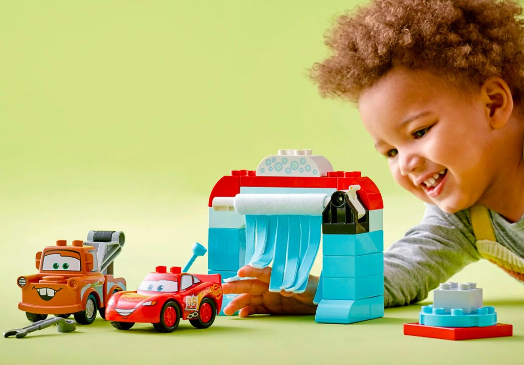 child playing with lego duplo cars set