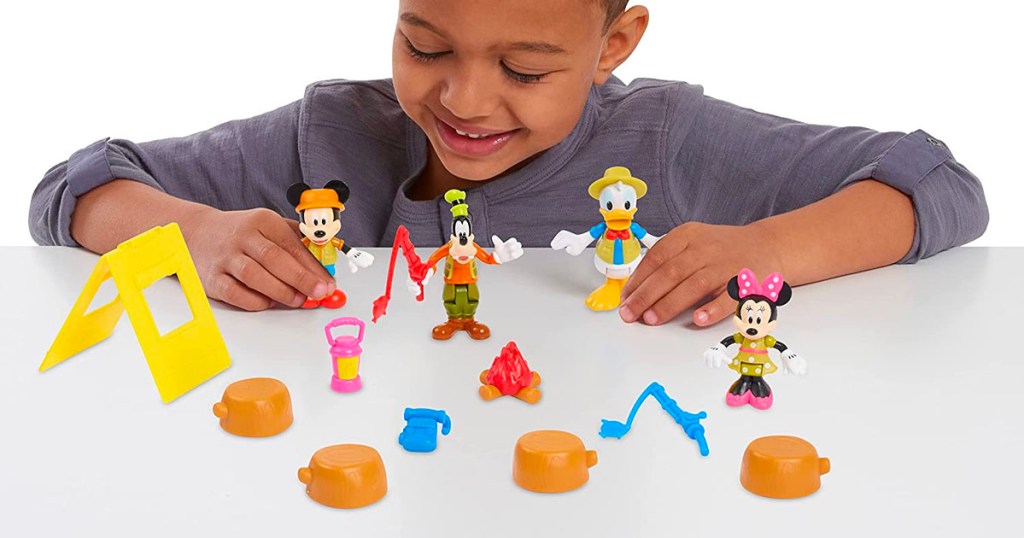 child playing with mickey mouse camping figure set