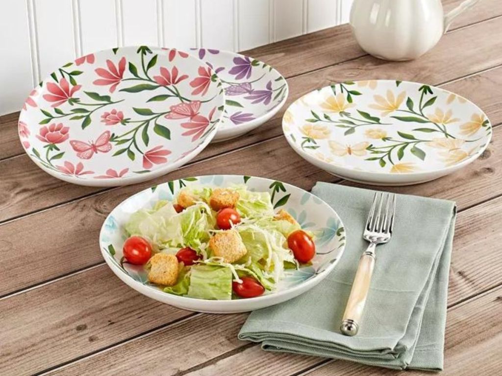 various butterfly and floral plates on wood table