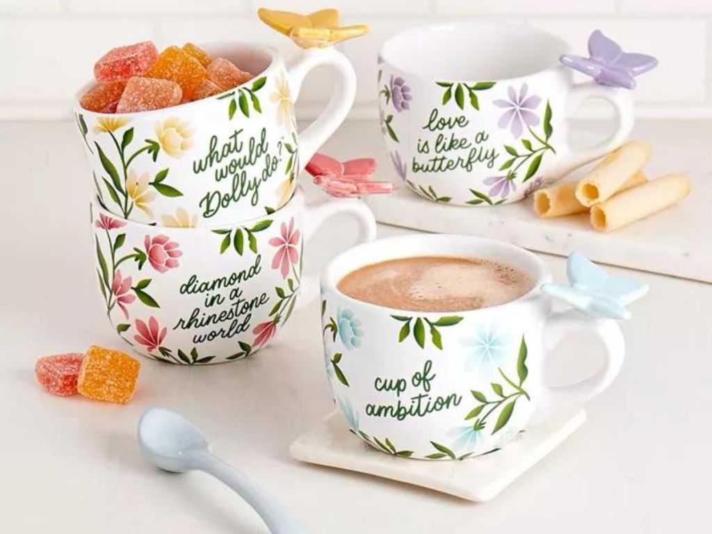 butterfly and floral Dolly Parton mugs on table 
