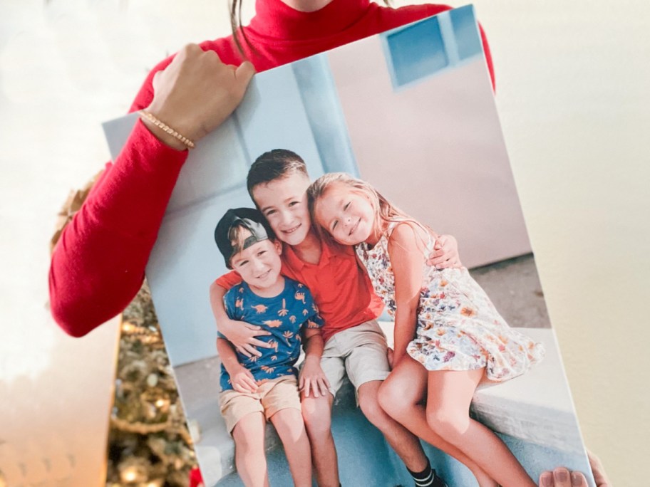 arms holding large canvas print against body