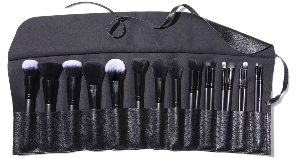 black makeup brush roll holder filled with brushes
