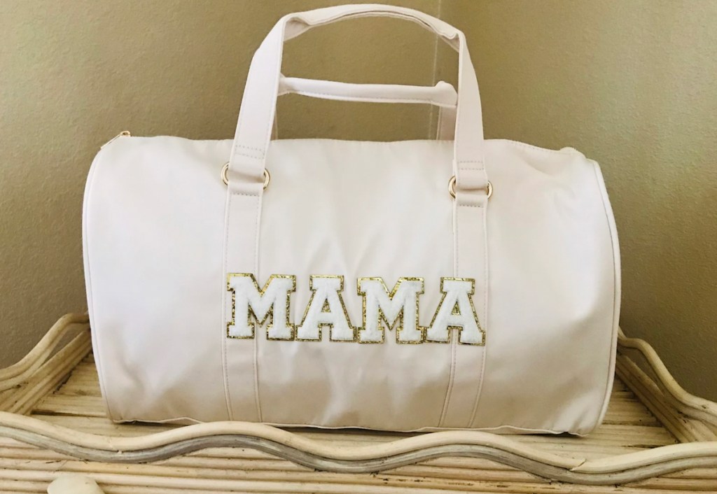 white mama duffle bag on wooden tray