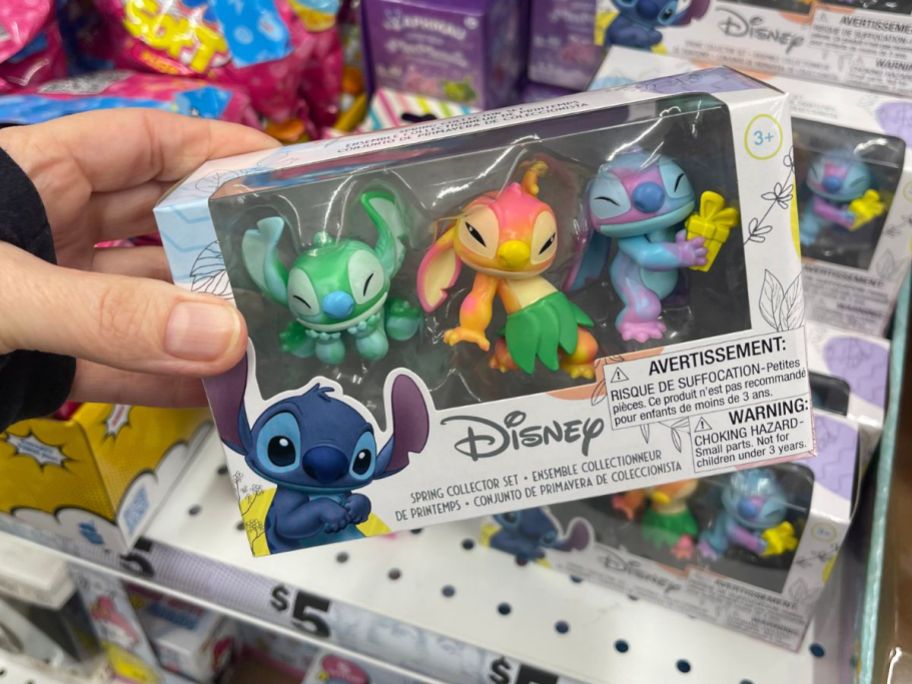 hand holding a Disney Stitch mini figure pack