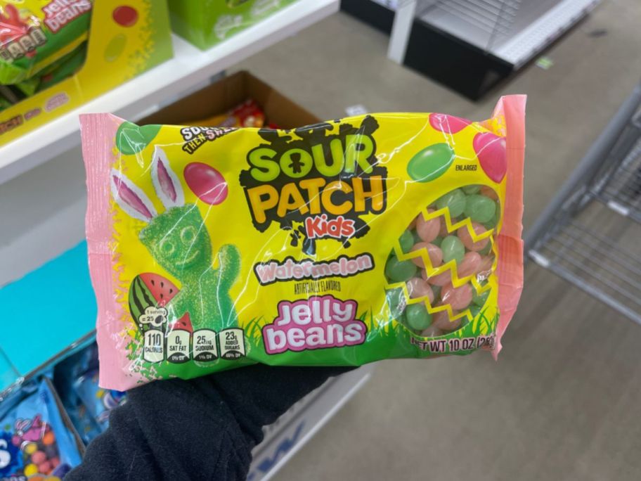 hand holding bag of sour patch jelly beans