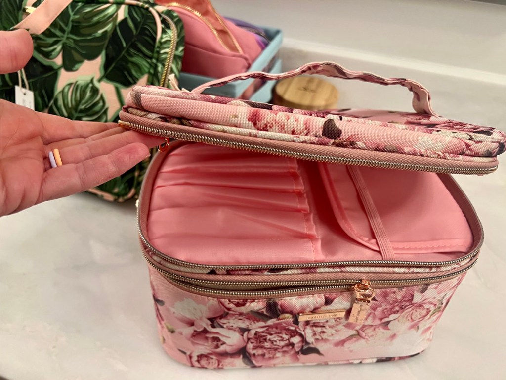 hand opening top of pink floral makeupbag