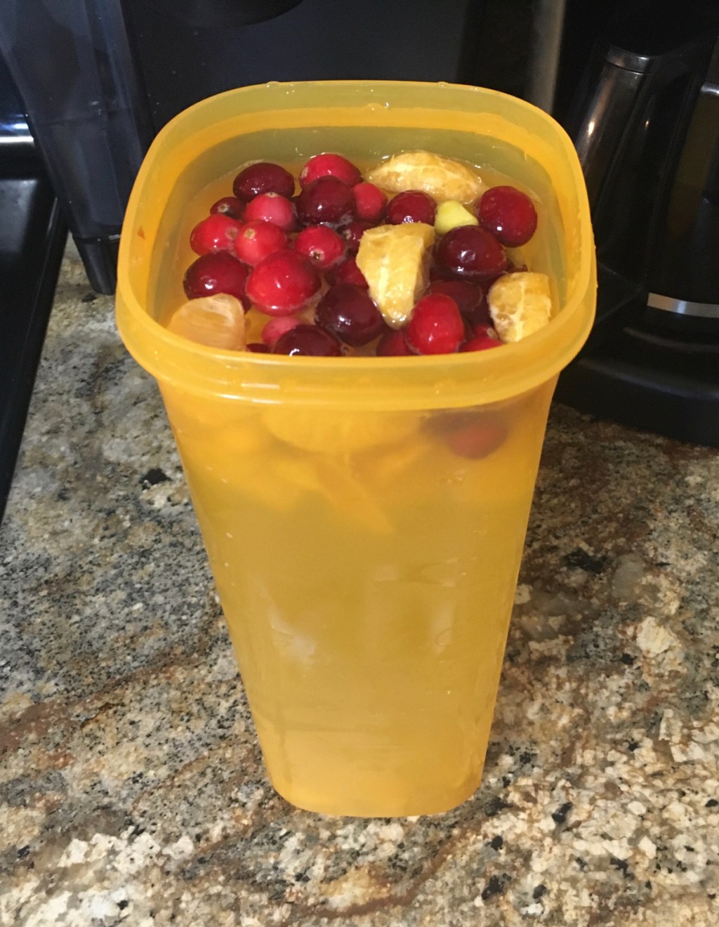 container filled with fruit and water