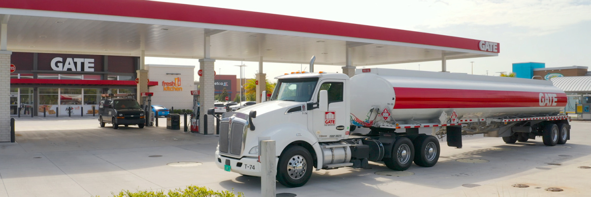 A semi-truck outside a GATE Gas station that has free air